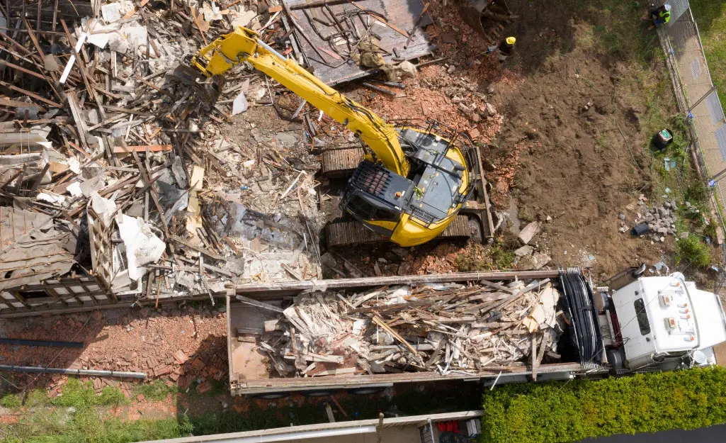 Aerial view of demolition debris being loaded into a haul truck