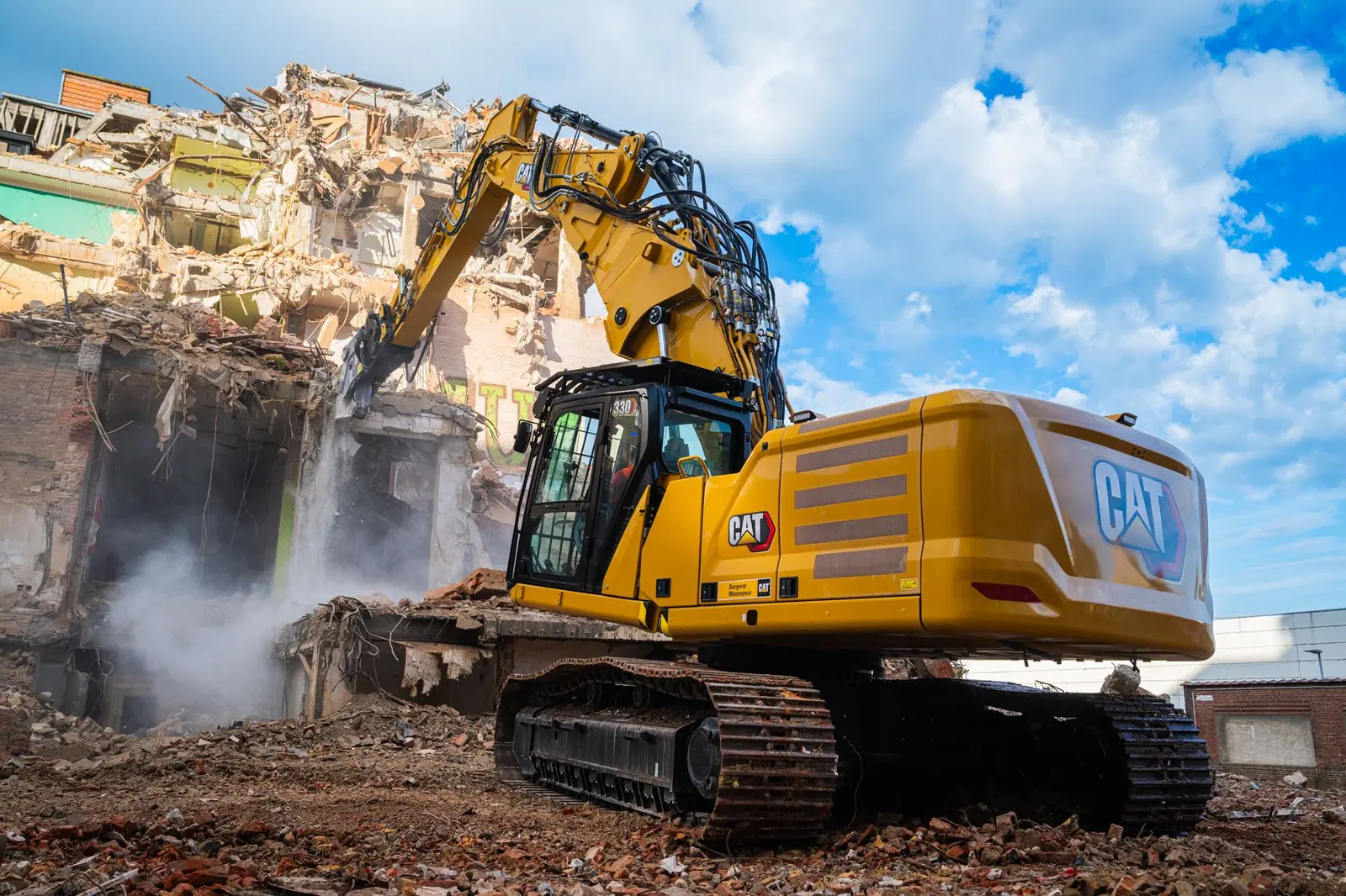 Tracked excavator clearing a heavy construction site